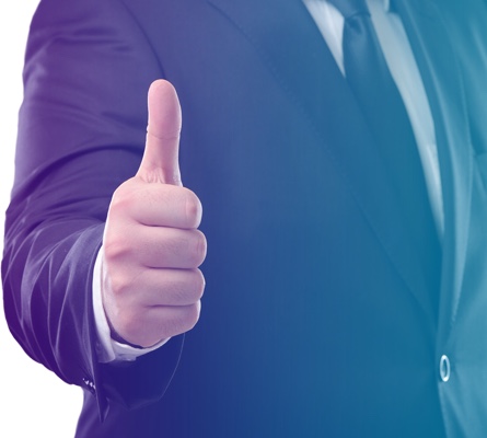 Man in suit giving a thumbs up sign